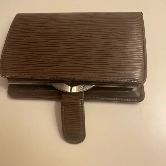 Louis Vuitton wallet. Dark brown in good condition.